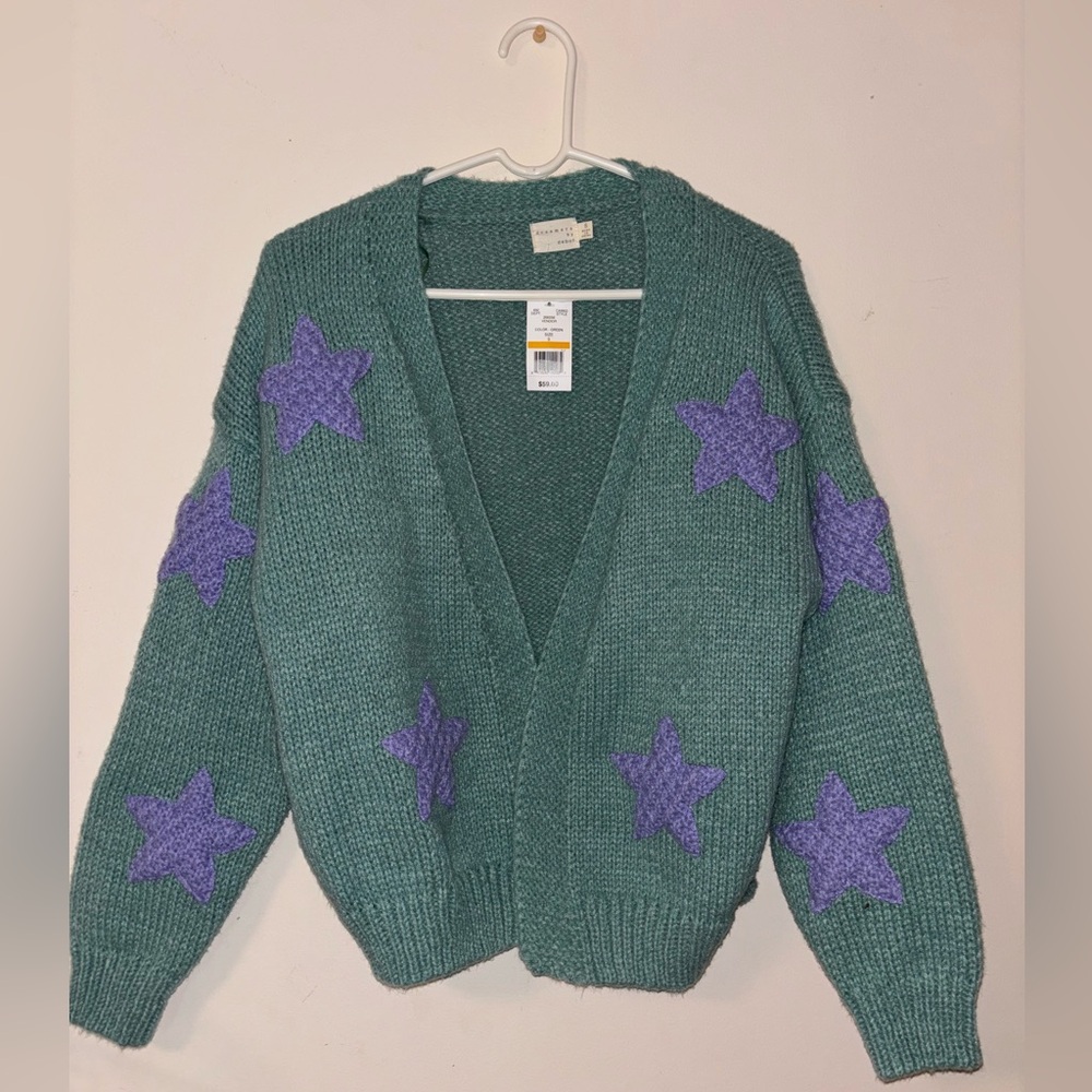 Green sweater/cardigan with purple stars. Never worn